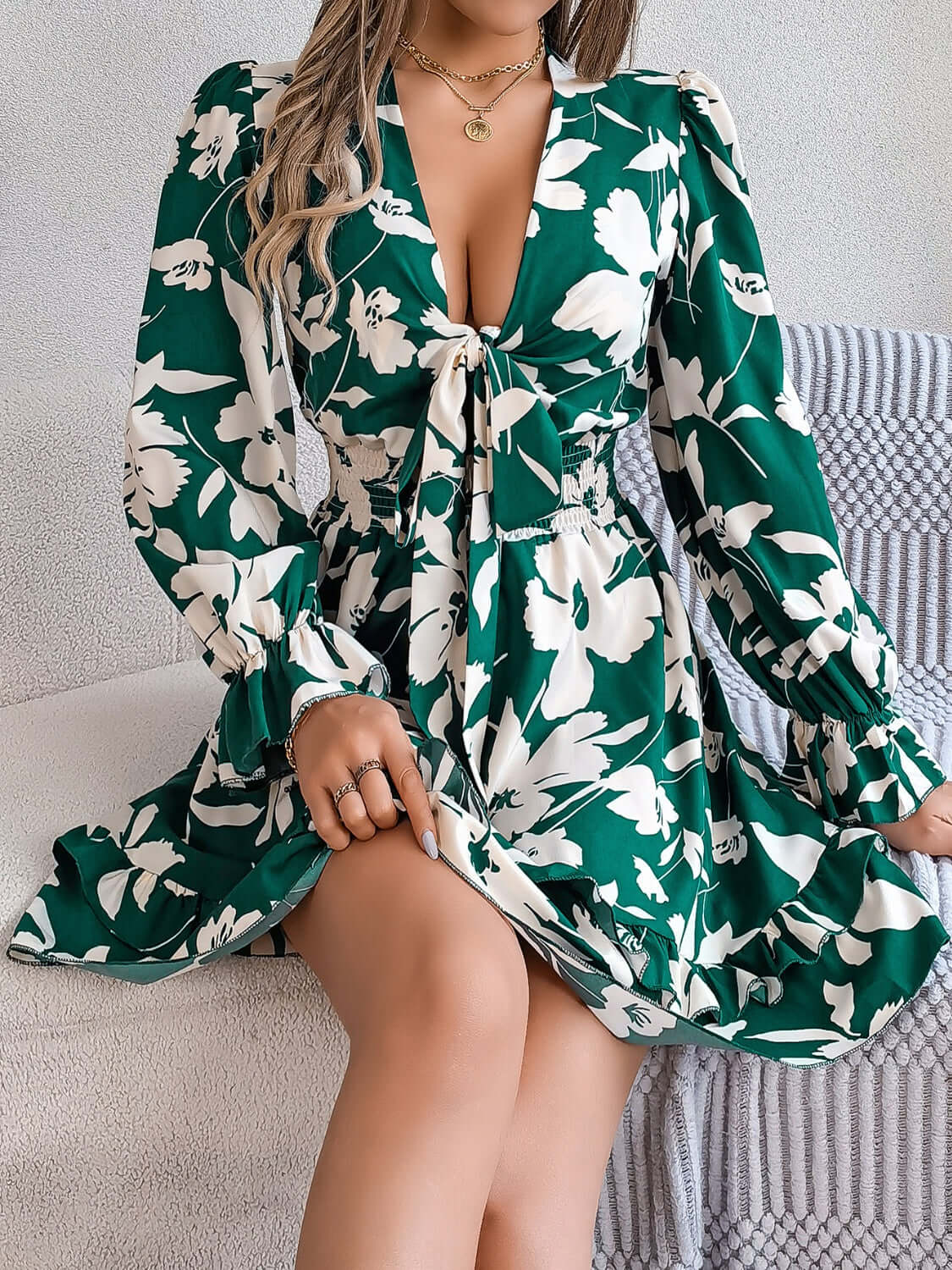 Green floral ruffled long sleeve dress with a tied front, perfect for stylish summer outings.