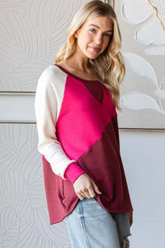 Model wearing HOPELY color block long sleeve T-shirt in bold pink and maroon, showcasing a stylish casual look.
