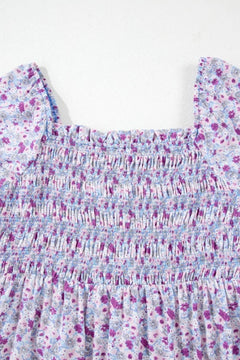 Close-up of the shirred bodice and floral print of a Tiered Floral Shirred High Waist Maxi Dress.