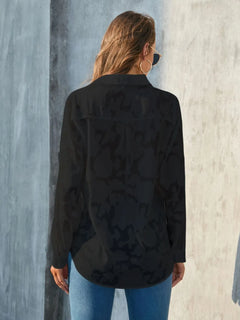 Back view of Full Size Collared Neck Long Sleeve Shirt Plus Size in black, showcasing its semi-sheer design and relaxed fit.