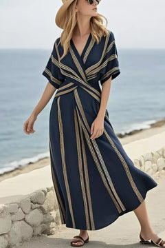 Model showcasing a Striped Wrap Half Sleeve Maxi Dress by the ocean, perfect for summer outings.