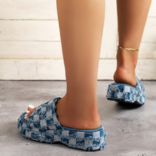 Fashionable denim slide sandals featuring a chic woven design, perfect for casual looks this season.