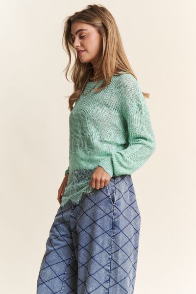 Model wearing a mint green lace detail long sleeve knit top paired with light blue patterned pants.