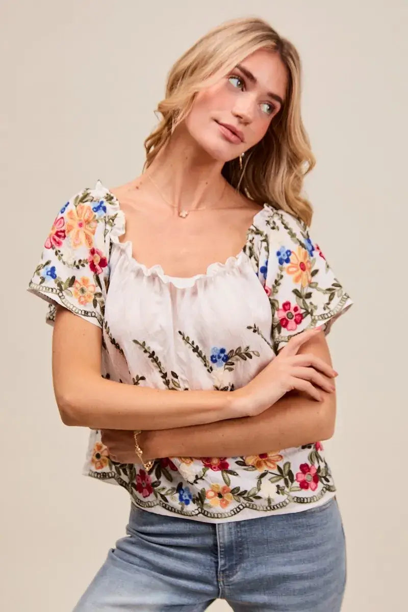 Model wearing SO ME Floral Embroidered Two Way Off The Shoulder Blouse styled with floral embroidery.