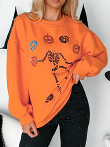 Halloween skeleton pumpkin sweatshirt with sequins, vibrant orange color, cozy style for festive occasions.