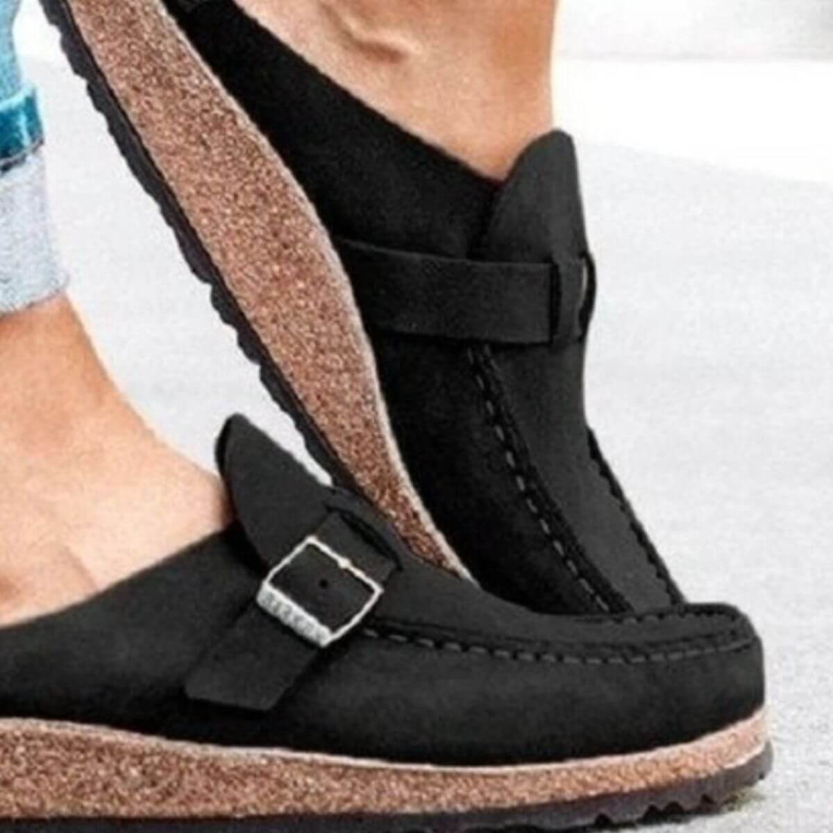Round toe low heel black loafers with buckle detail, showcasing a comfortable fit and stylish design.
