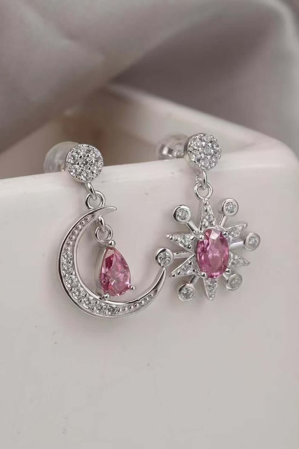 2 carat Moissanite 925 sterling silver earrings featuring a moon and star design with pink accents.