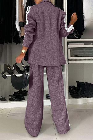 Back view of a woman in a full-size contrast lapel collar top and pants set, showcasing its stylish design.