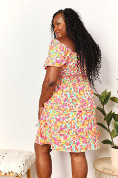 Devine Smocked Sweetheart Neck Flounce Sleeve Mini Dress featuring smocked detailing and floral pattern.