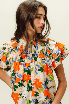 BiBi Multi Color Floral Print Woven Top featuring a vibrant floral pattern and ruffled design for a stylish summer look.