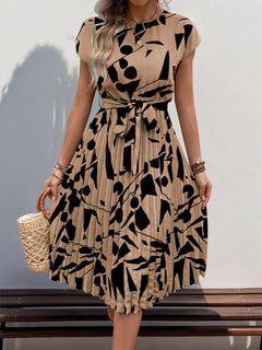 Tied pleated printed cap sleeve dress in beige with black abstract patterns, perfect for stylish summer outings.