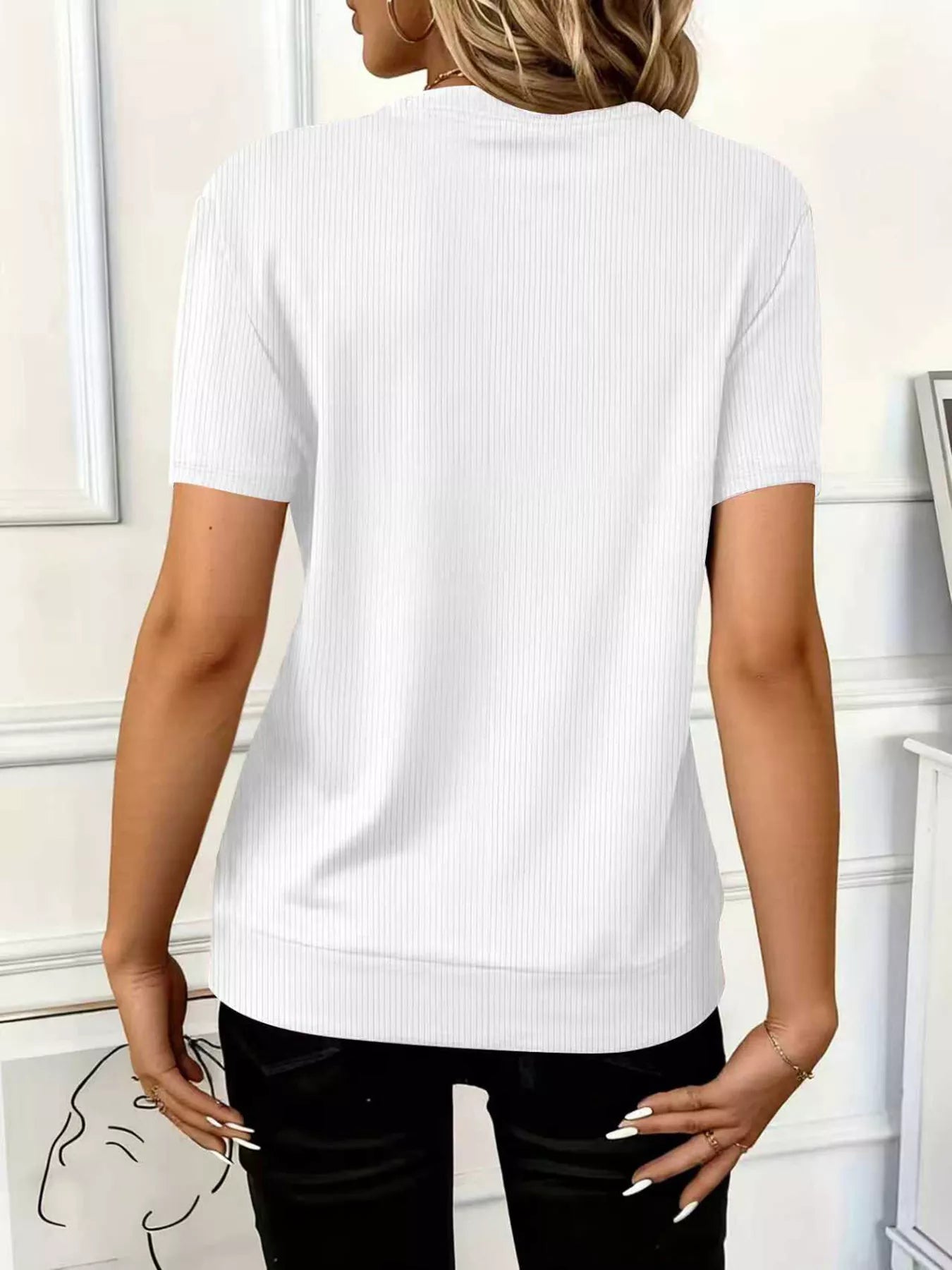 Back view of a woman wearing a stylish Half Zip Short Sleeve Top in white, highlighting its ribbed texture and short sleeves.