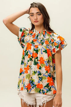 BiBi Multi Color Floral Print Woven Top featuring a vibrant floral design and ruffled details, perfect for a summery look.