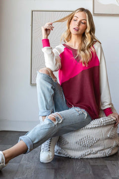 Model wearing a HOPELY color block long sleeve T-shirt, styled with ripped jeans for a casual look.