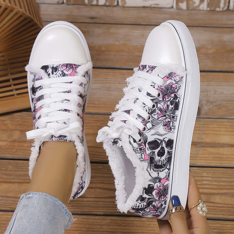 Raw hem printed canvas sneakers featuring floral and skull design, perfect for casual wear.