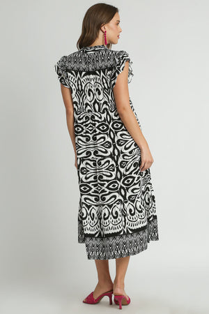 Back view of Umgee plus size two-tone border print ruffle cap sleeve midi dress in black and white.