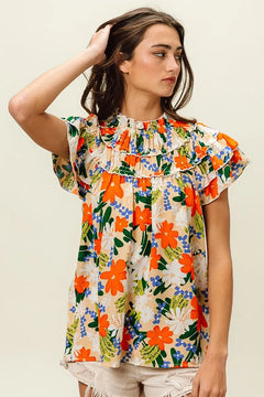 BiBi Multi Color Floral Print Woven Top worn by a model, featuring vibrant florals, frills, and a cheerful style.