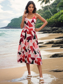 Pleated geometric spaghetti strap dress in vibrant colors, perfect for beachwear. Features a stylish, comfortable design.