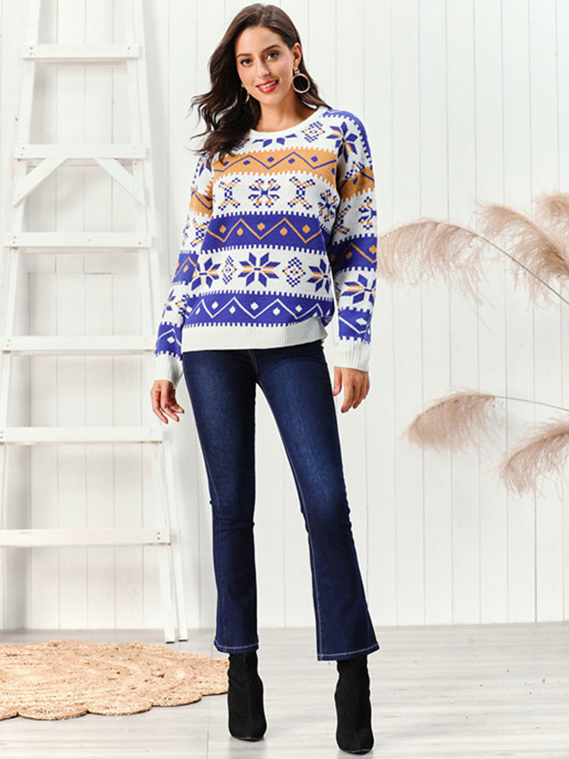 Snowflake Pattern Round Neck Sweater displayed on a model, showcasing its vibrant colors and festive design.