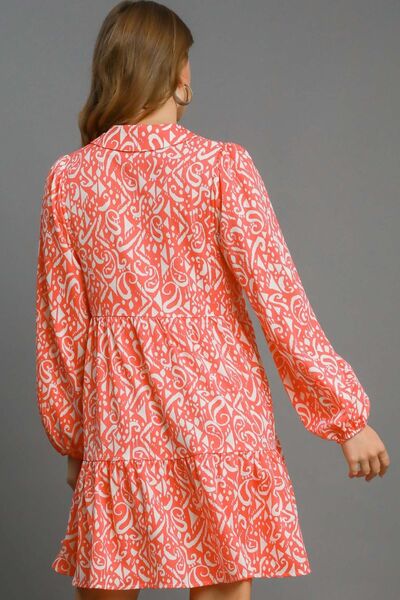 Back view of Umgee two-tone boho print balloon sleeve tiered dress in coral and white, showcasing a trendy silhouette.