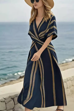 Model wearing a Striped Wrap Half Sleeve Maxi Dress by the seaside, showcasing an elegant summer look.