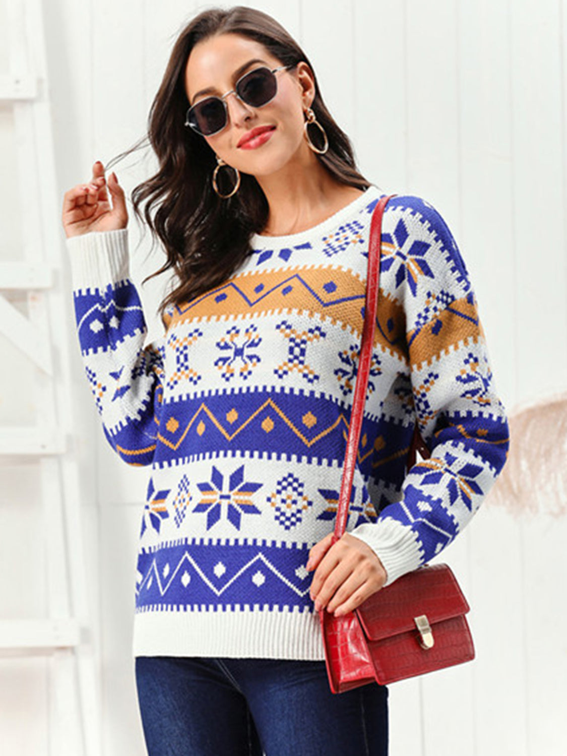 Model wearing a Snowflake Pattern Round Neck Sweater featuring colorful designs and a stylish red handbag.