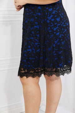 Close-up of Yelete lace midi dress showcasing contrasting blue and black lace design for an elegant look.