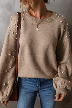 Women's pearl detail round neck long sleeve sweater in beige, styled with jeans and accessories, perfect for casual elegance.