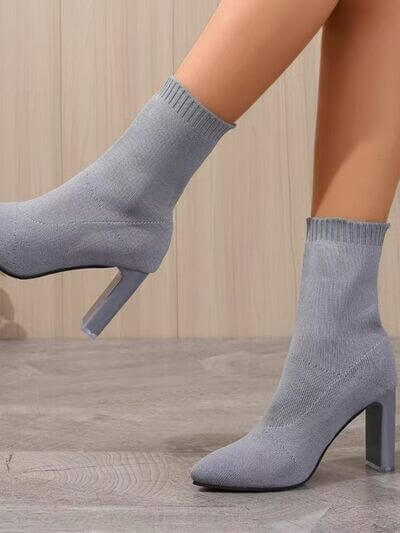 Stylish gray point toe block heel boots with high heels, perfect for fashion-forward outfits.