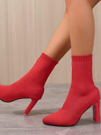 Red point toe block heel boots with a knitted ankle design, showcased elegantly against a neutral background.