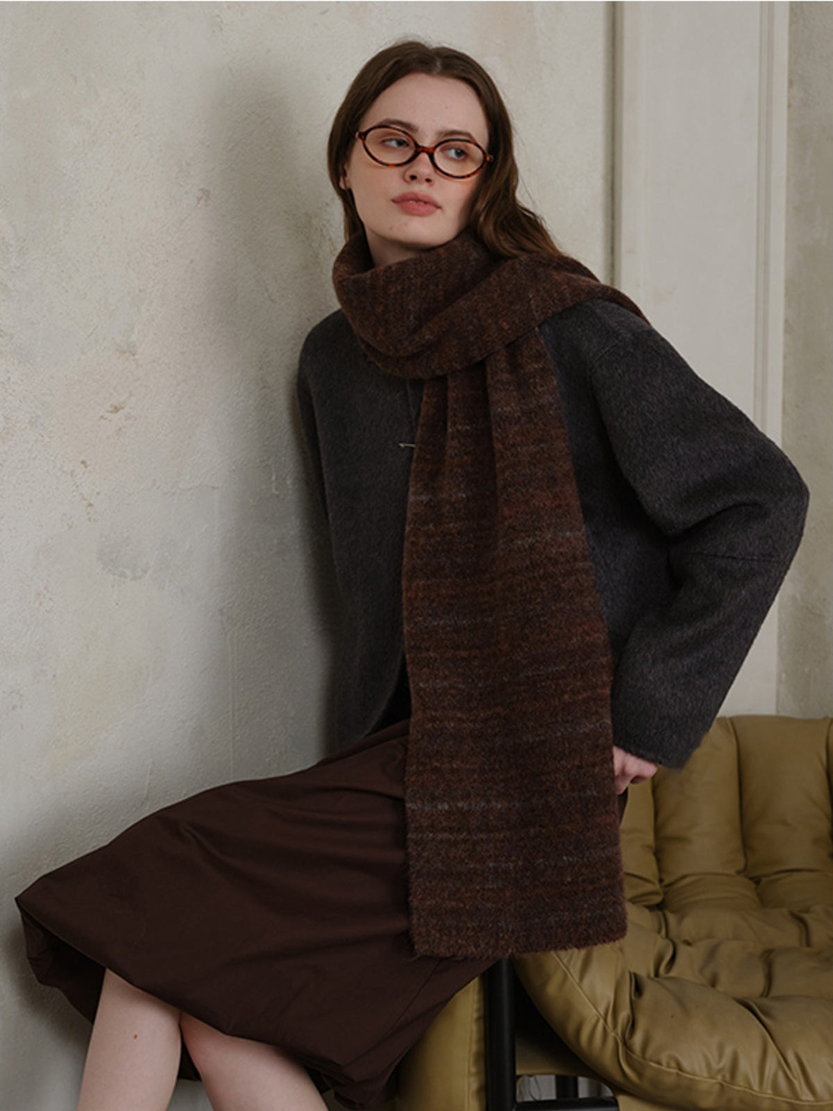 Fashionable striped detail knit scarf in rich brown hues, made from soft fur for warmth and style.