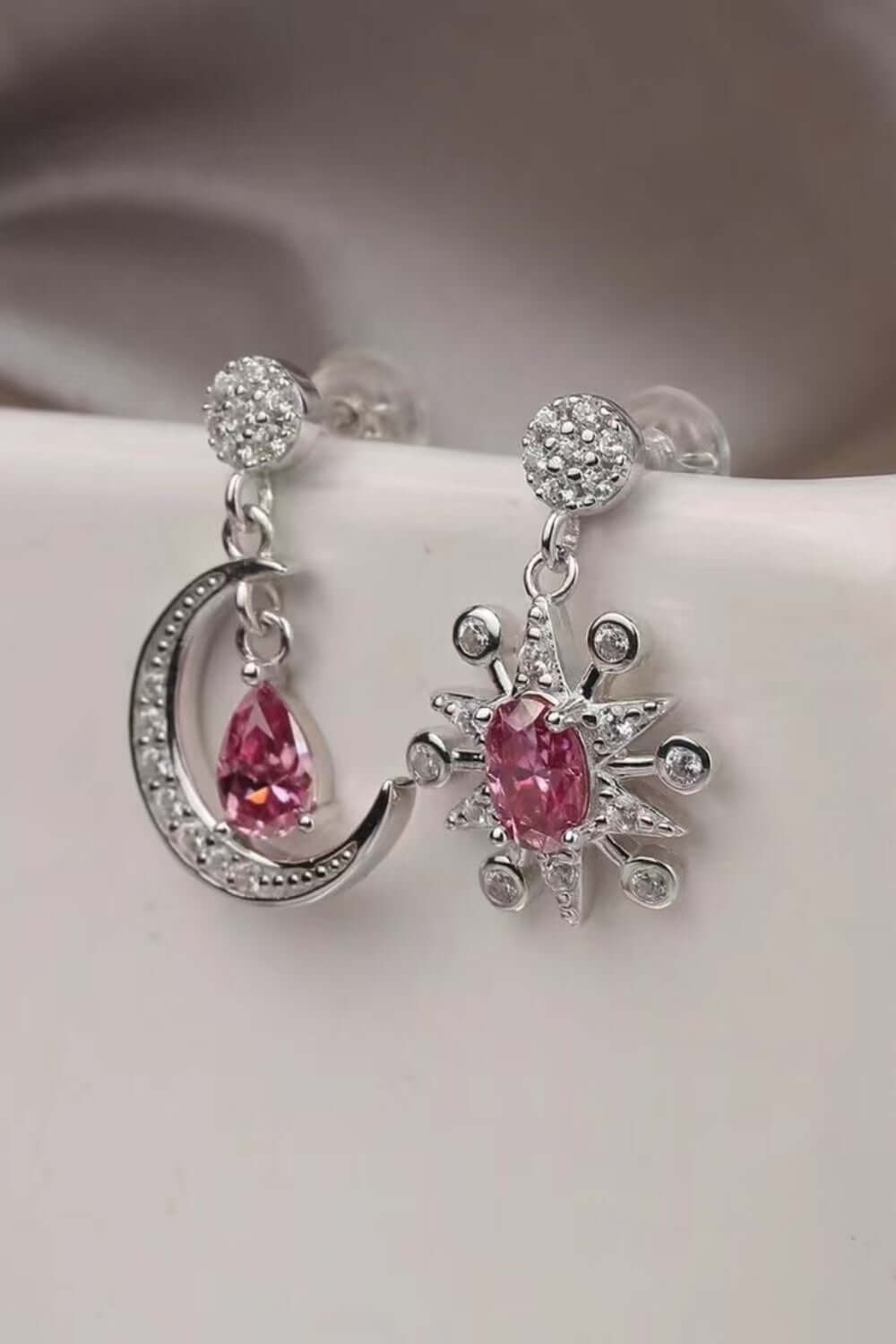 2 carat moissanite 925 sterling silver earrings showcasing moon and star designs with pink stones.