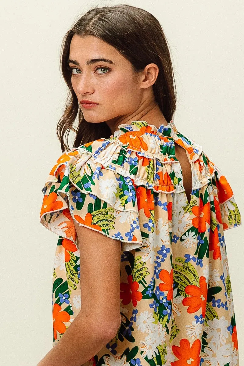 Model showcasing BiBi Multi Color Floral Print Woven Top featuring a vibrant floral design and ruffled details.