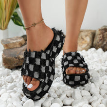 Stylish plaid platform sandals in black and white, perfect for elevating casual and chic outfits.
