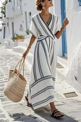 Stylish model wearing a Striped Wrap Half Sleeve Maxi Dress with a straw bag, showcasing trendy summer fashion.