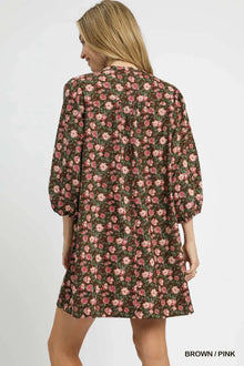 Back view of the Umgee Floral Tie-Neck Babydoll Dress in brown and pink, showcasing its charming floral print and puff sleeves.