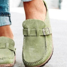 Green round toe low heel buckle loafers worn with casual jeans, showcasing stylish and comfortable footwear.