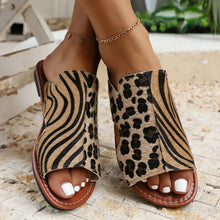 Fashionable open toe flat sandals with leopard and zebra prints, perfect for summer and casual outfits.
