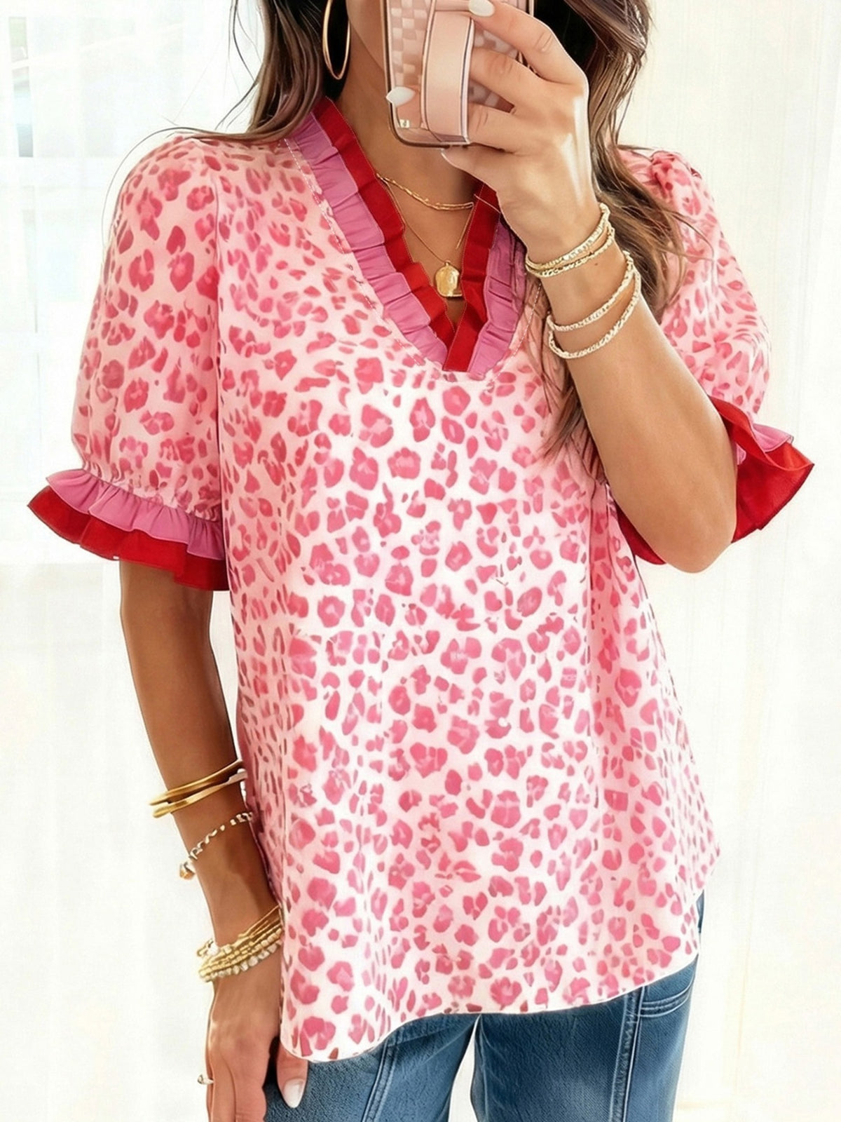 Leopard Print Frill Short Sleeve Blouse featuring ruffled sleeves and a stylish pink leopard print design.