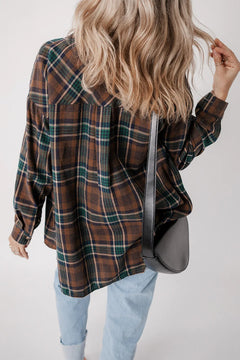 Stylish woman wearing a plaid button-up long sleeve jacket with a shoulder bag.
