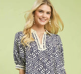 Umgee Geometric Leaf Print Popover Top in a relaxed fit with stylish geometric leaf motif and V-notch neckline.