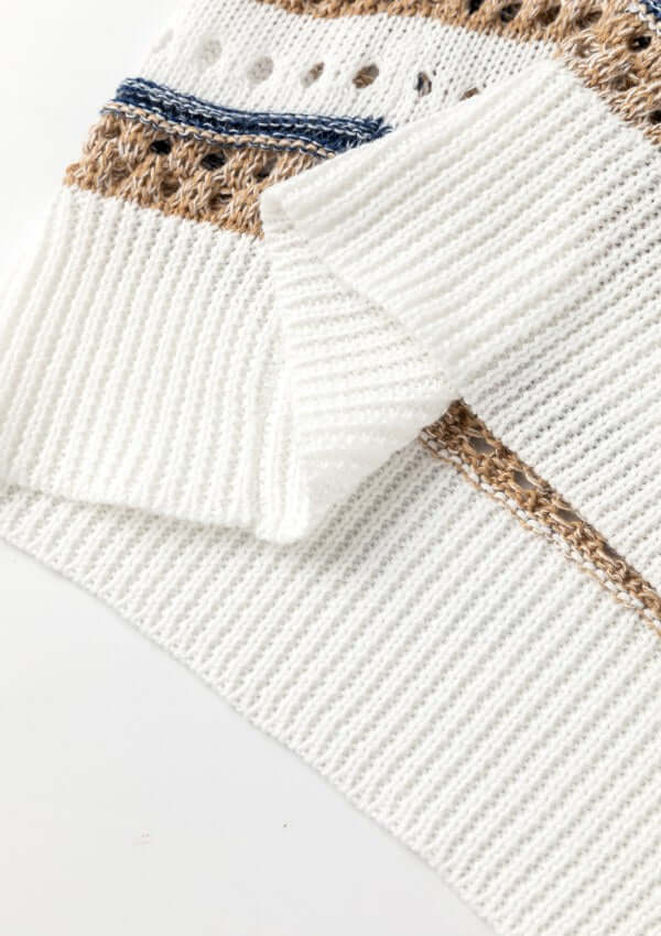 Close-up of a striped hollow out half sleeve knit top showcasing openwork design and knitted texture.