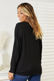 Double Take Seam Detail Round Neck Long Sleeve Top in black, showcasing a relaxed fit and seam detailing from the back.
