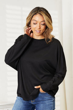 Double Take Seam Detail Round Neck Long Sleeve Top worn by a model, showing its elegant fit and versatile black design.