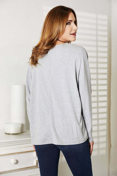 Back view of a model wearing a Double Take Seam Detail Round Neck Long Sleeve Top in gray.