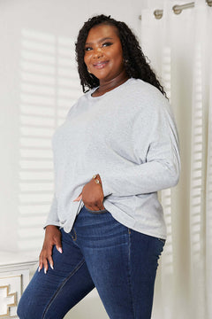 Model wearing Double Take Seam Detail Round Neck Long Sleeve Top in grey with stylish seam detail.