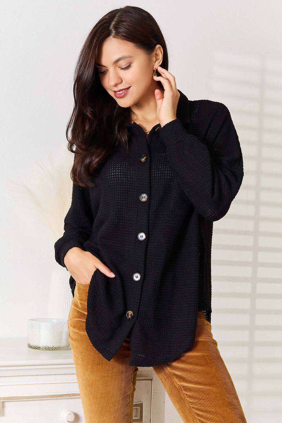 Model wearing a Double Take Waffle-Knit Collared Neck Dropped Shoulder Shirt in black, styled with corduroy pants.