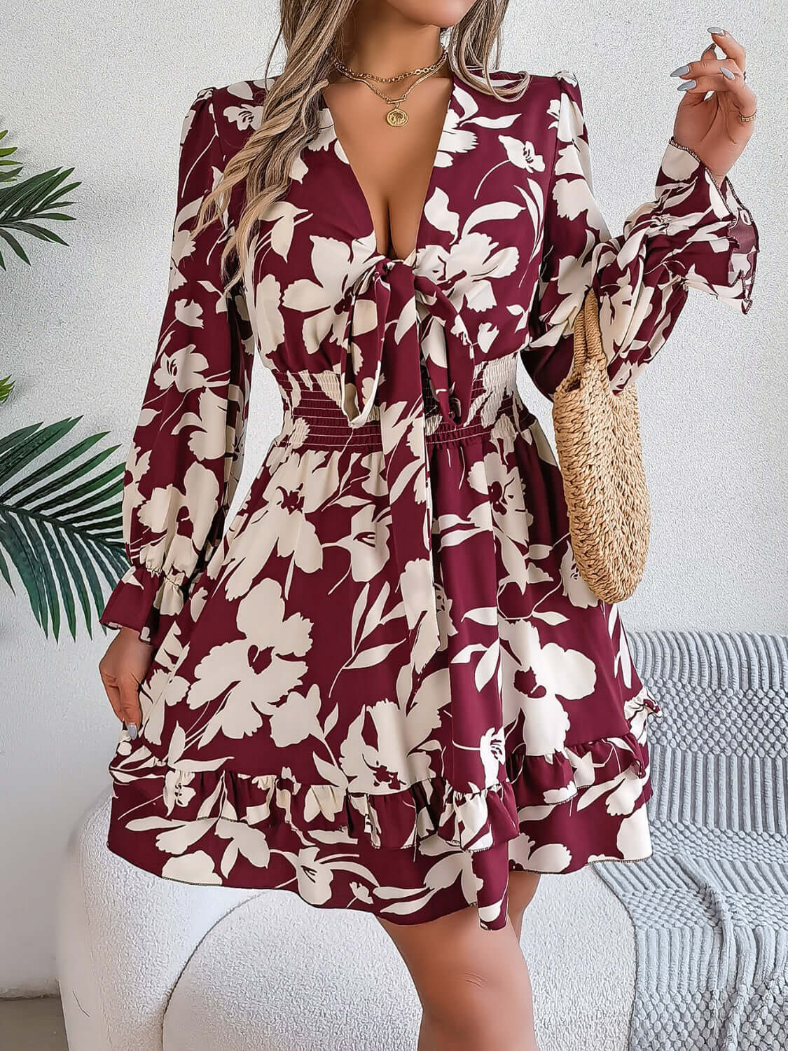 Tied ruffled long sleeve dress in burgundy and white floral print, perfect for casual outings.