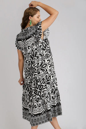 Umgee full-size two-tone border print ruffle cap sleeve midi dress in black and white, featuring feminine details and elegant design.