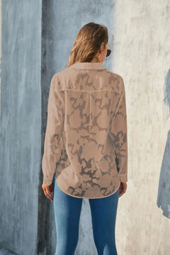 Back view of a model wearing a Full Size Collared Neck Long Sleeve Shirt Plus Size with a light camouflage pattern.